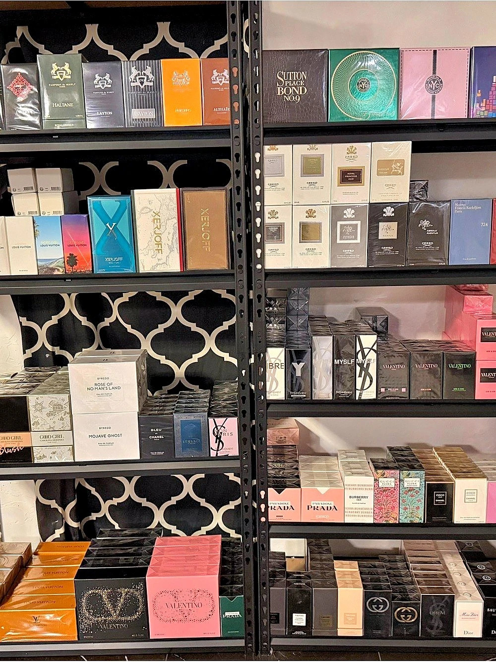 A luxurious perfume collection beautifully displayed on organized shelves, featu